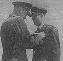Fig. 12. Colonel Ramsay D. Potts pins DFC on Lt. Donald O. Jones